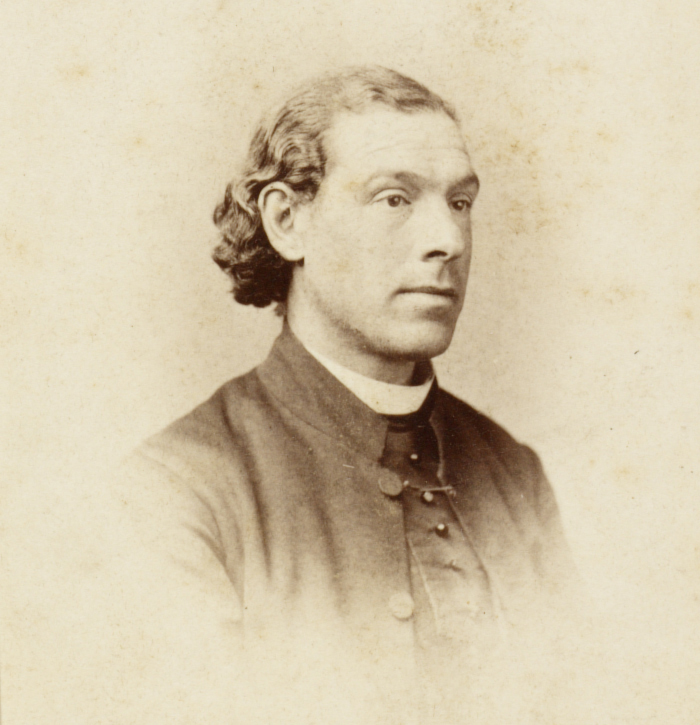 A historical photograph of Julian Tenison Woods, depicted in a sepia-toned portrait.