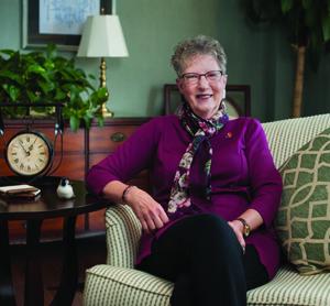 An image of Davida Foy Crabtree sitting on a sofa.
