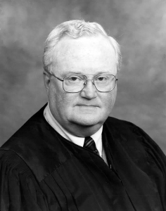 White man in judges robe.