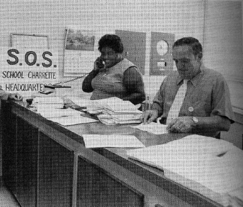 Ann Atwater and Claiborne Ellis standing at an office counter.
