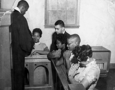 Photo of the Rev. Douglas Moore, and African-American students.