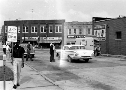 Street view from the late 50's with striking workers holding signs.