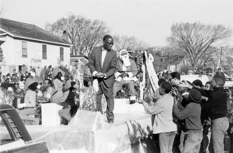 A Christmas float with an African-American Santa Claus.