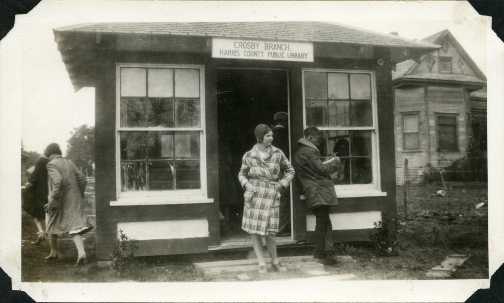 A woman exits the Crosby Library, which is a small one room building, not much more than a shed.