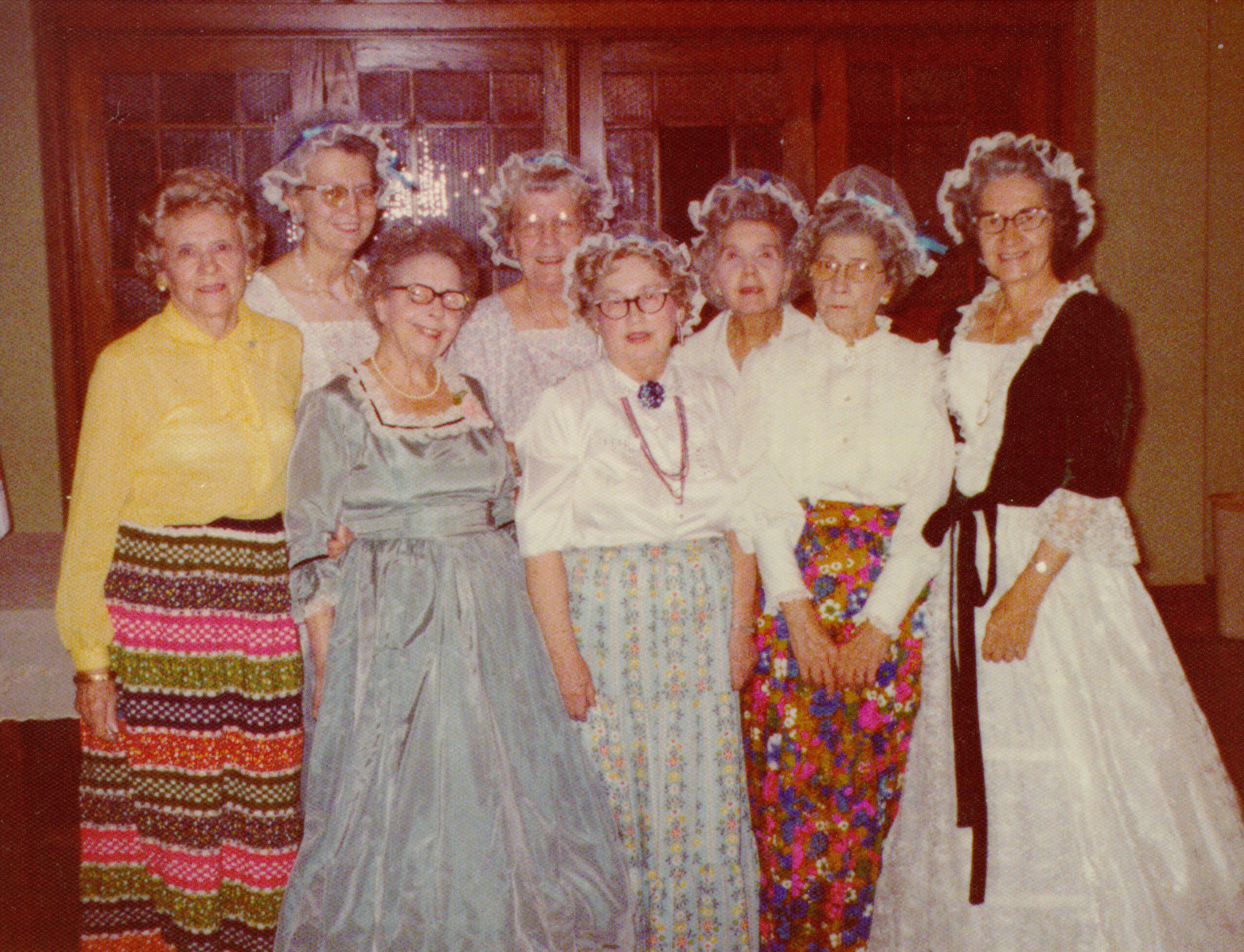 A group of older women, some of whom are dressed in 19th century garb.