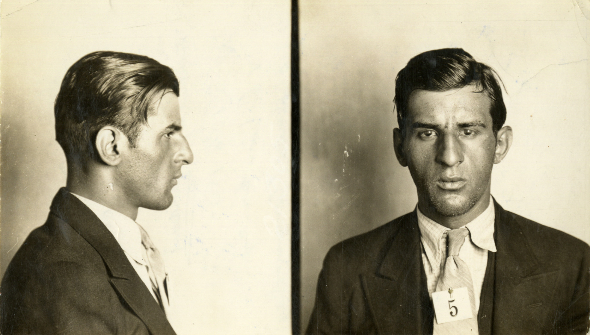 Man with slick hair in both a profile and straight-ahead pose