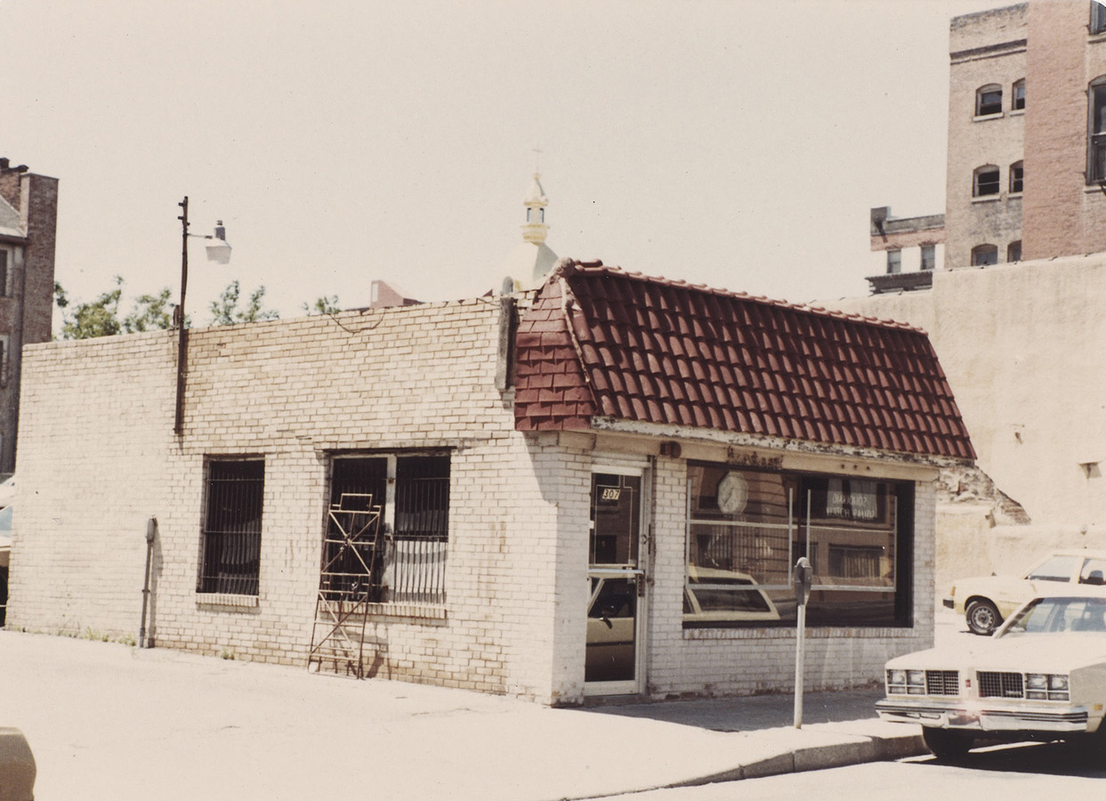 A small commercial storefront building with a spanish tile awning.