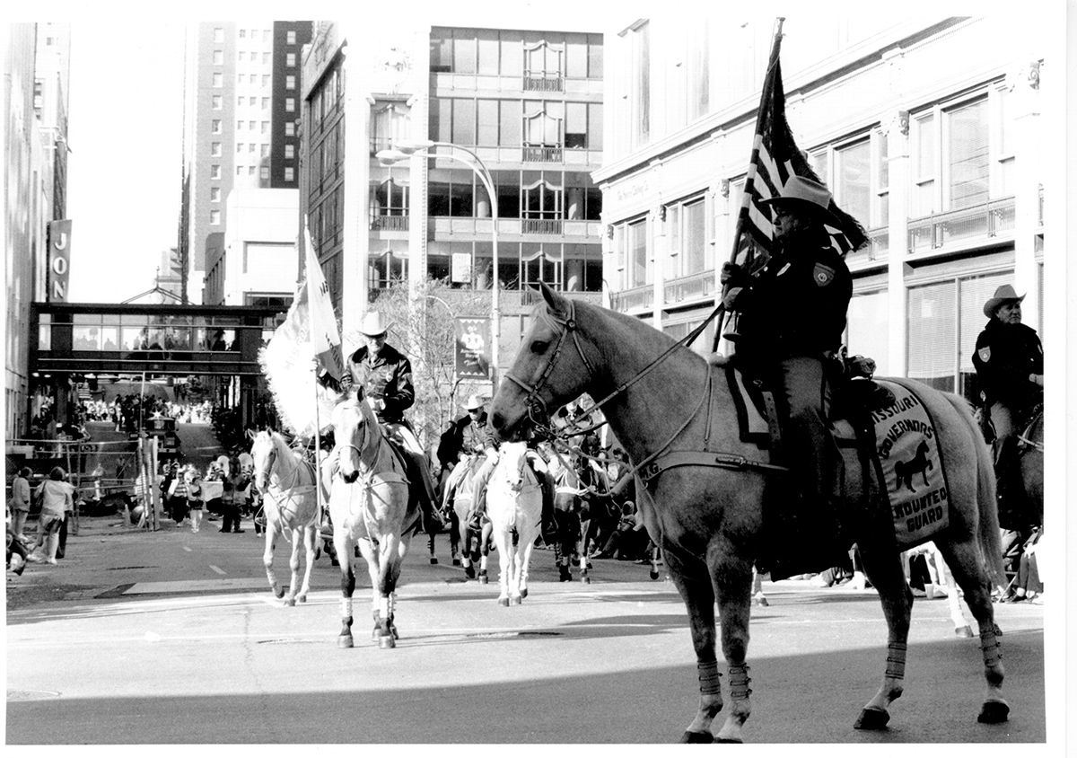 people on horseback riding in a parade