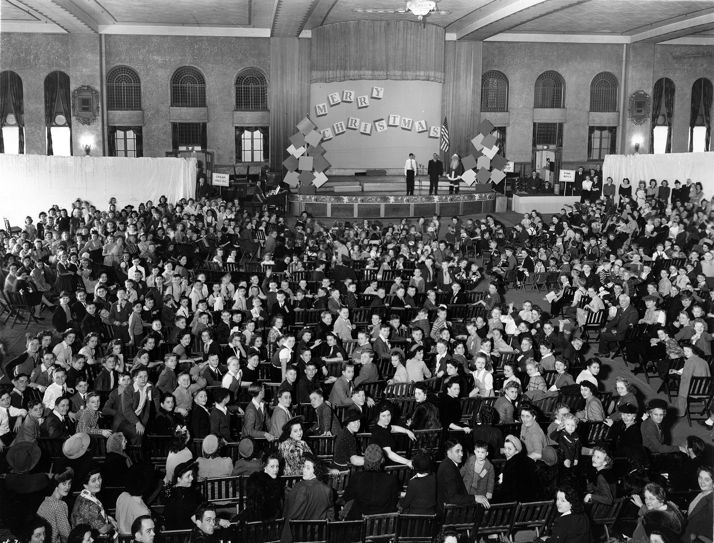 A large gropu of women seated in an auditorium.