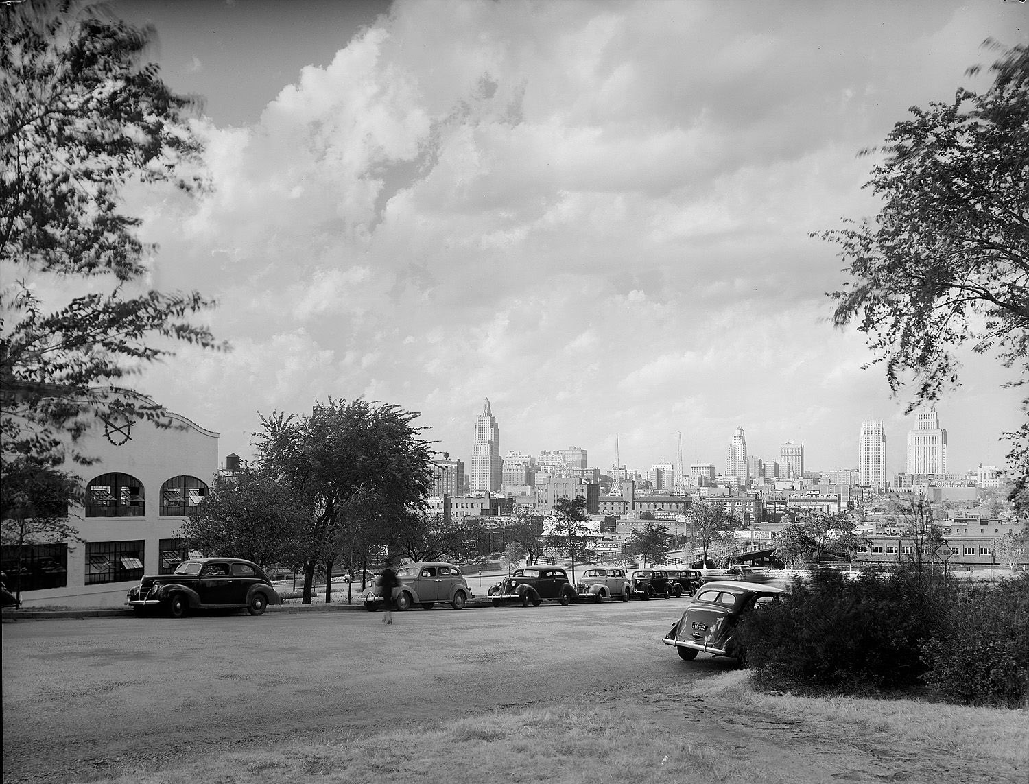 A street view with a city skyline visible in the distance