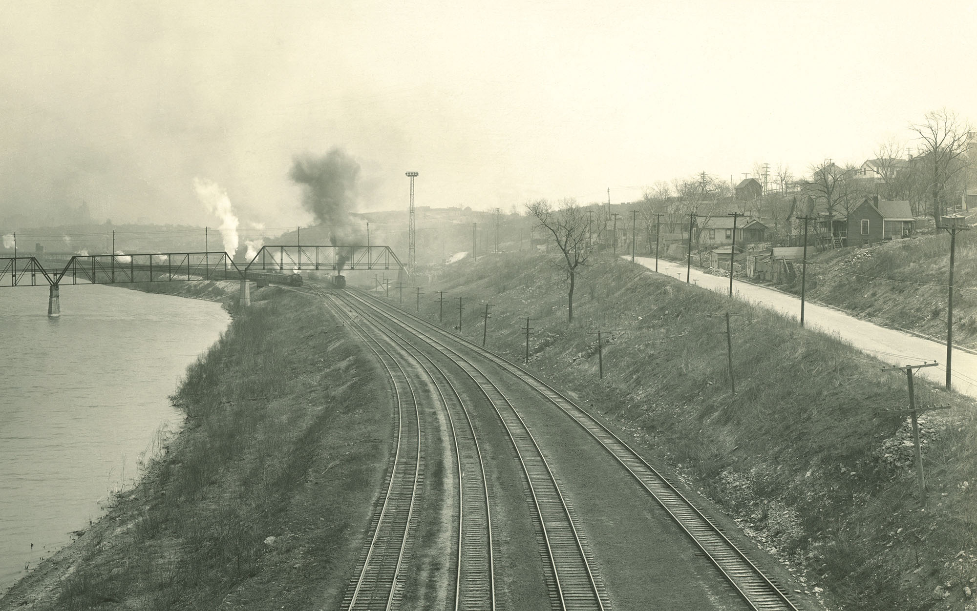 Railroad tracks on an embankment above a river