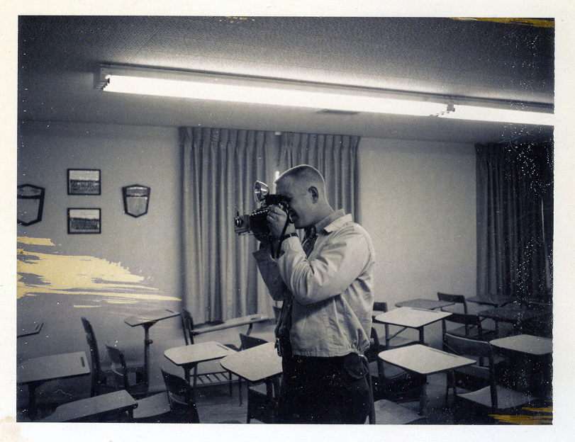 photograph of Officer Tom Jones holding a camera and taking a picture