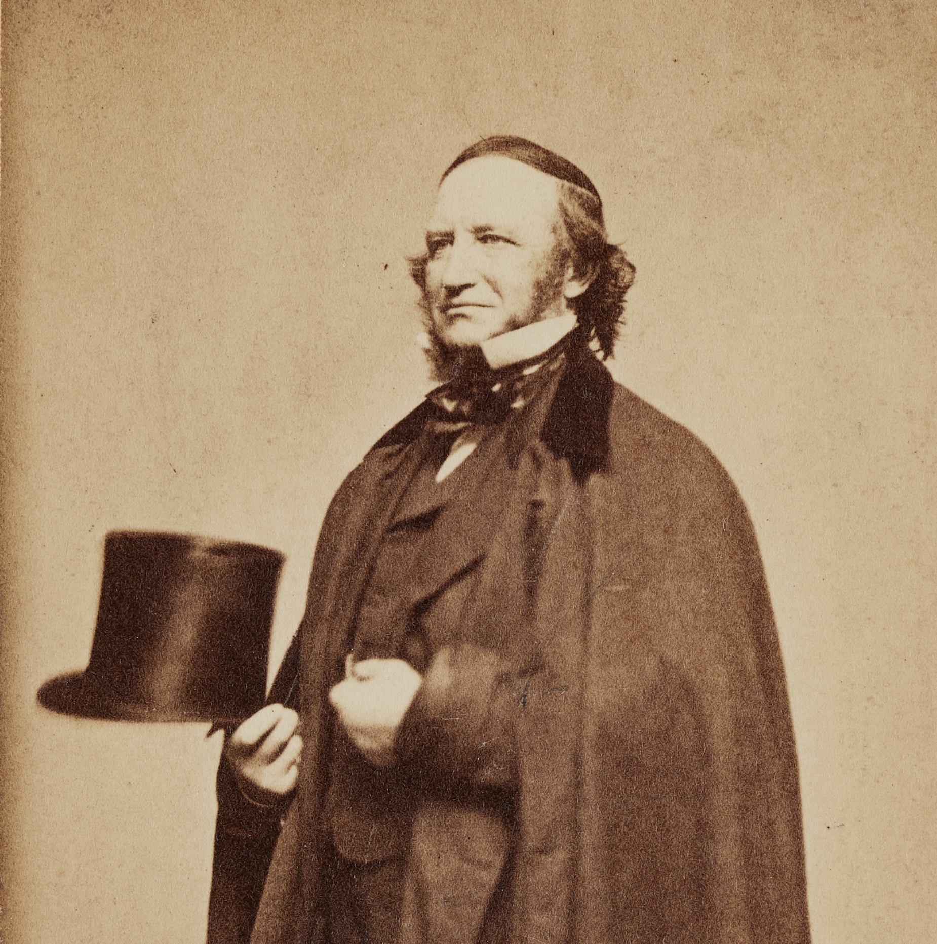A studio portrait of Richard P. Waters in formal wear holding a top hat.