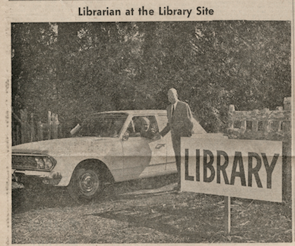 Newspaper clipping of a car sitting beside a sign that says LIBRARY.