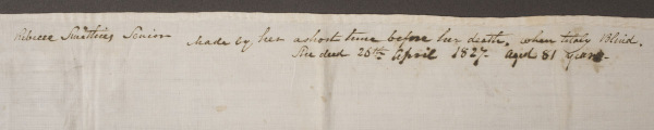 Photograph of the upper portion of the handkerchief showing the full inscription about Rebecca Smithies Sr.