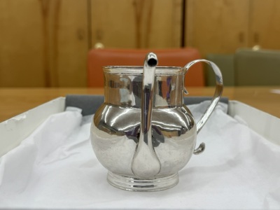 A view of the cup from the user’s perspective. The spout’s top arches above the cup’s rim and dips toward the user. The spout leans slightly to the right.